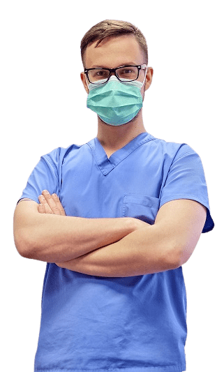 A dentist in scrubs and a surgical mask, arms folded.